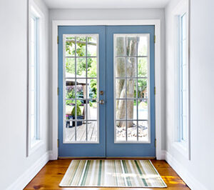 blue double doors with colonial grids, white walls