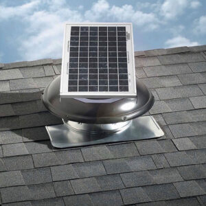 Solar attic fan on shingled roof under blue sky.