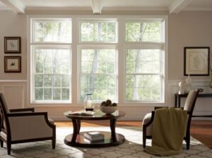 Bright living room with large windows and armchairs