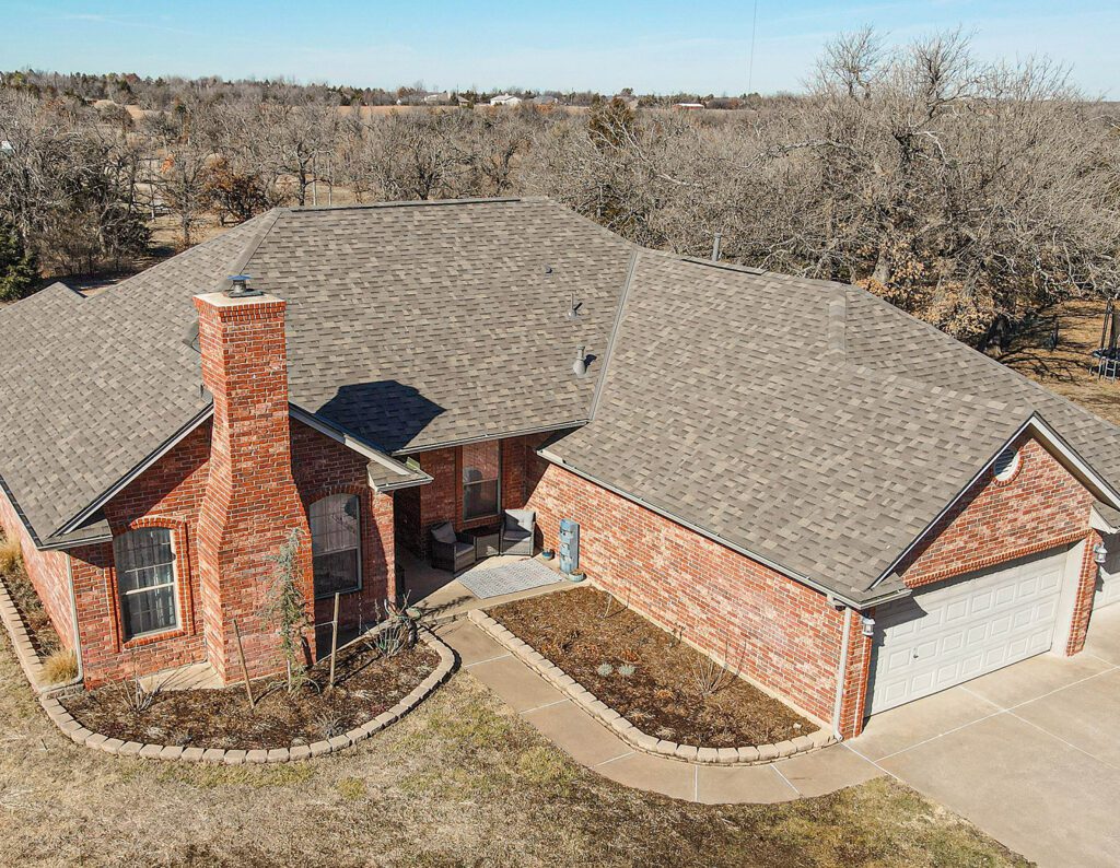 Brick house with large shingled roof and garage