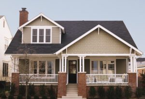 Charming two-story house with porch and gable roof.