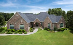 Brick house with landscaped yard and trees