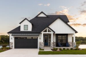 Modern house with black garage and blue door.