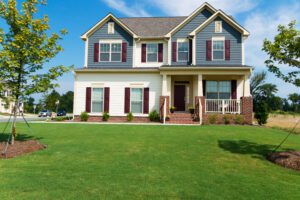 colonial house with blue and white siding, burgundy shutters