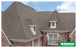 Brick house with gray shingle roof.