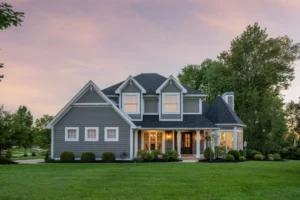 Charming suburban house at sunset with green lawn.