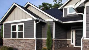 Modern house exterior with dark siding and stone