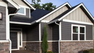 Modern house with gray siding and stone accents.