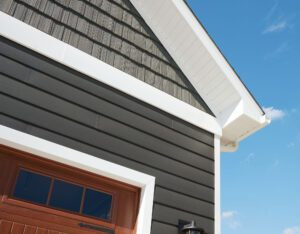 Modern house gable with dark siding and white trim.