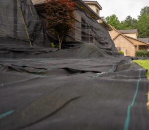 Landscape with ground cover fabric near house.