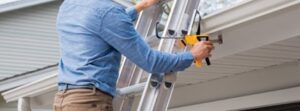 Man using a ladder latch pro to secure his ladder