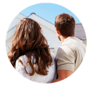 Couple looking at the roof of a house