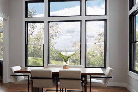 Modern dining room with large windows and scenic view.