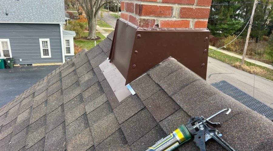 Roof chimney with brown flashing installation process.