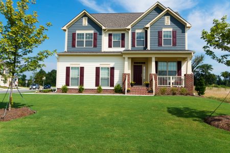 colonial house with blue and white siding, burgundy shutters