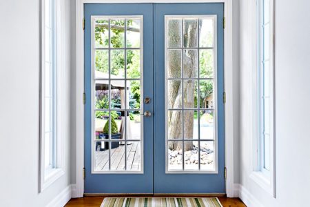 blue double doors with colonial grids, white walls