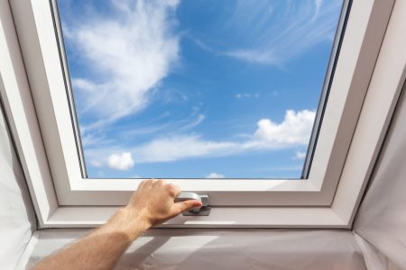 Man,Close,New,Skylight,(mansard,Window),In,An,Attic,Room