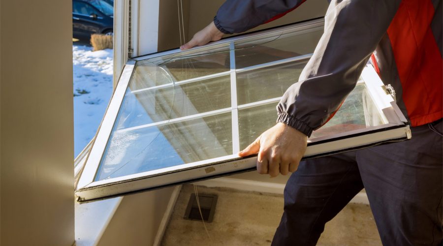 Person installing a home window pane.