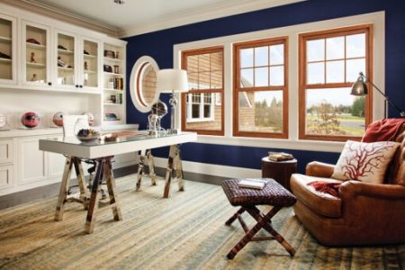 Cozy home office with leather chair and desk.
