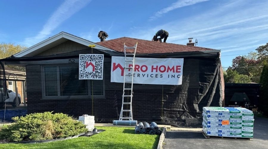 Home renovation with workers on roof and equipment.
