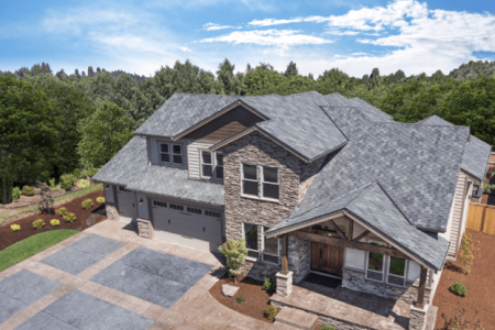 Modern house with stone facade and gray roof.